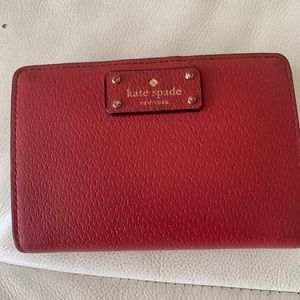 Red Kate Spade wallet with small tear